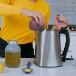 A person pouring oil into a cannabis edible maker