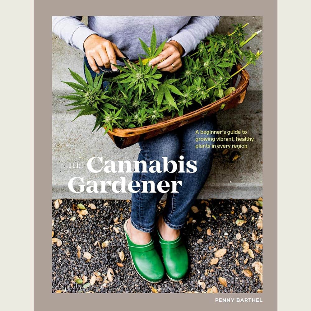The Cannabis Gardener book by Penny Barthel resting on a table beside a small potted cannabis plant and gardening tools, showcasing a beginner-friendly guide to home cultivation.