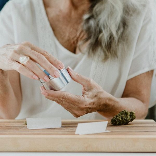 Woman using metal weed grinder