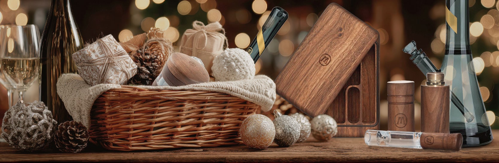 A curated cannabis gift basket featuring rolling trays, grinders, glassware, and decorative accents styled for a cozy holiday setting.
