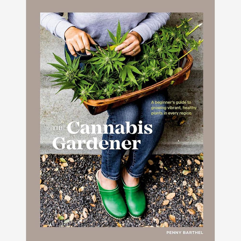 The Cannabis Gardener book by Penny Barthel resting on a table beside a small potted cannabis plant and gardening tools, showcasing a beginner-friendly guide to home cultivation.
